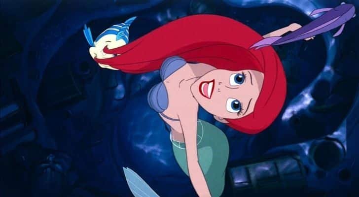 Ariel from the Little Mermaid looking up and dreaming about walking on land