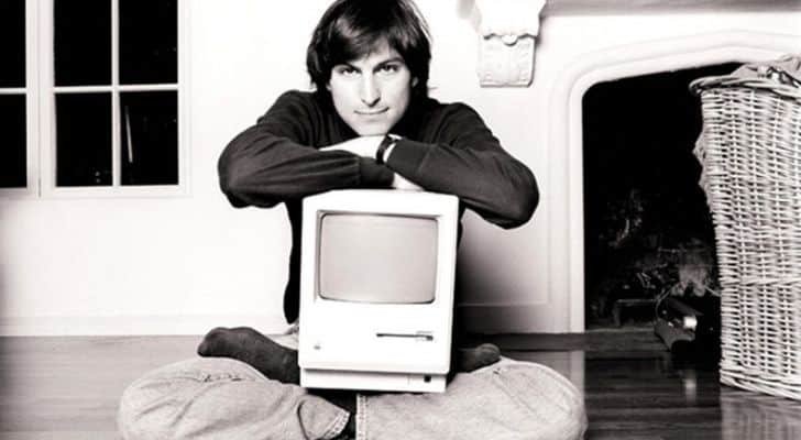 Steve Jobs with an Apple computer on his lap