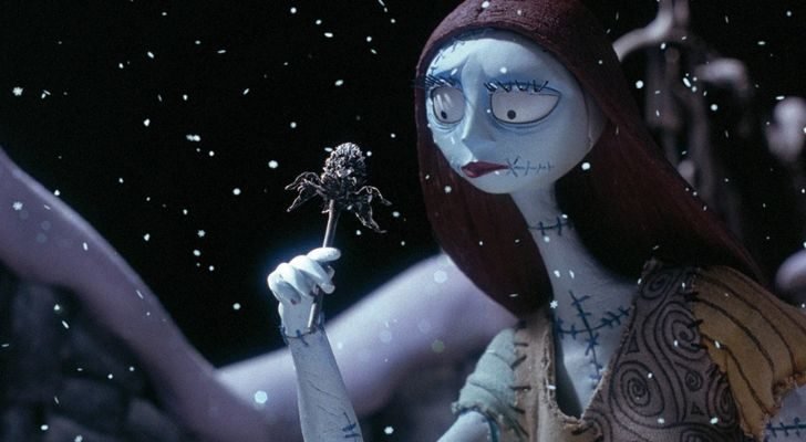 Sally from The Nightmare Before Christmas holding a flower in the snow