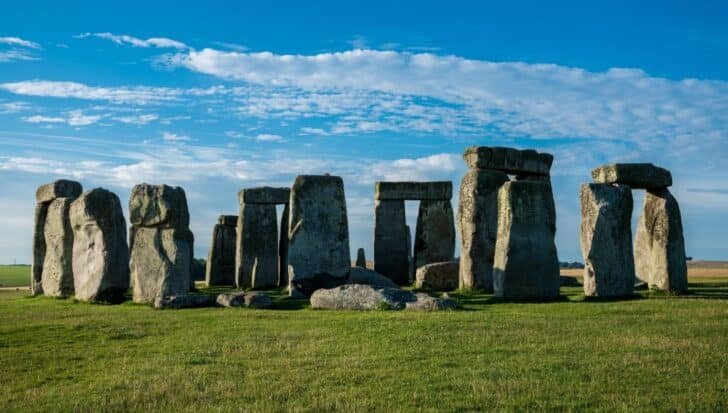 Stonehenge standing stones under a blue sky