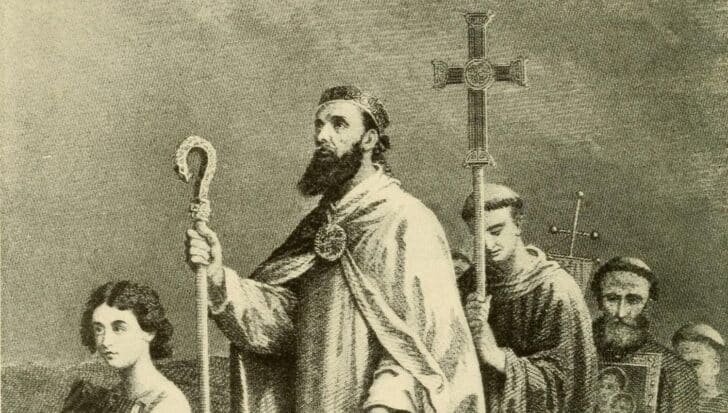 Illustration depicting Saint Patrick with a group of followers, holding a staff and cross