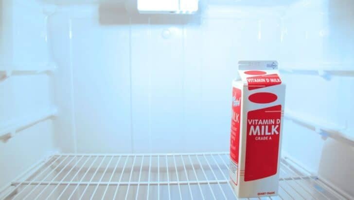 A carton of Vitamin D milk inside an empty refrigerator