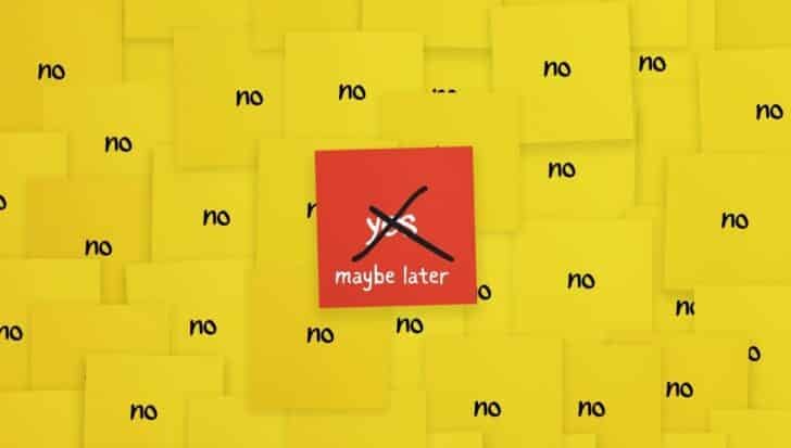 A cluster of yellow sticky notes with the word 'no' surrounding a red note that says 'maybe later' with 'yes' crossed out 