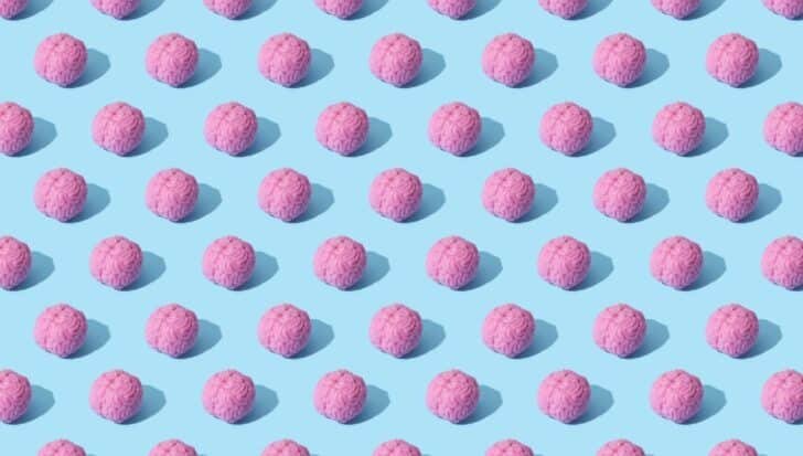 Pattern of pink brain-shaped objects on a light blue background