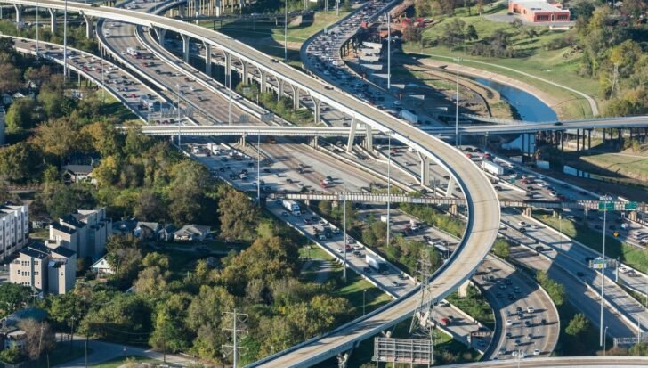 Aerial view of I-45 highway in Houston with heavy traffic and surrounding greenery